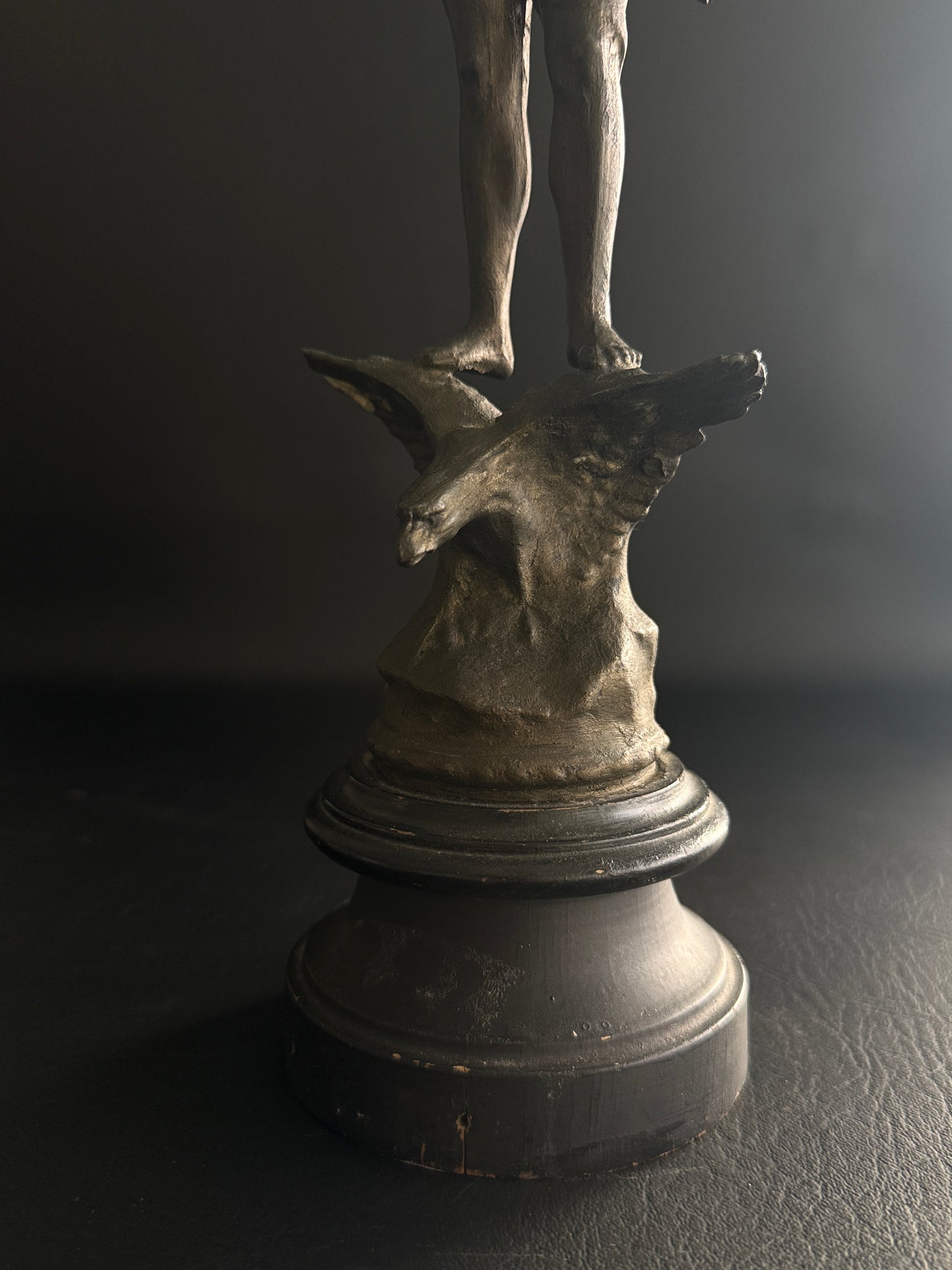 Antique Figural Metal Sculpture of Man Standing on Eagle with Wood Base